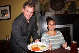 © Adam Brazeau Moustache Joe's owner Steve Montroy holds the Italian pasta trio dish being served during the festival. Waitress Emily Sabourin can't wait to dig in.